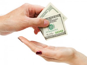 Hand Of Man Giving Hundred Dollars To Womans Hand